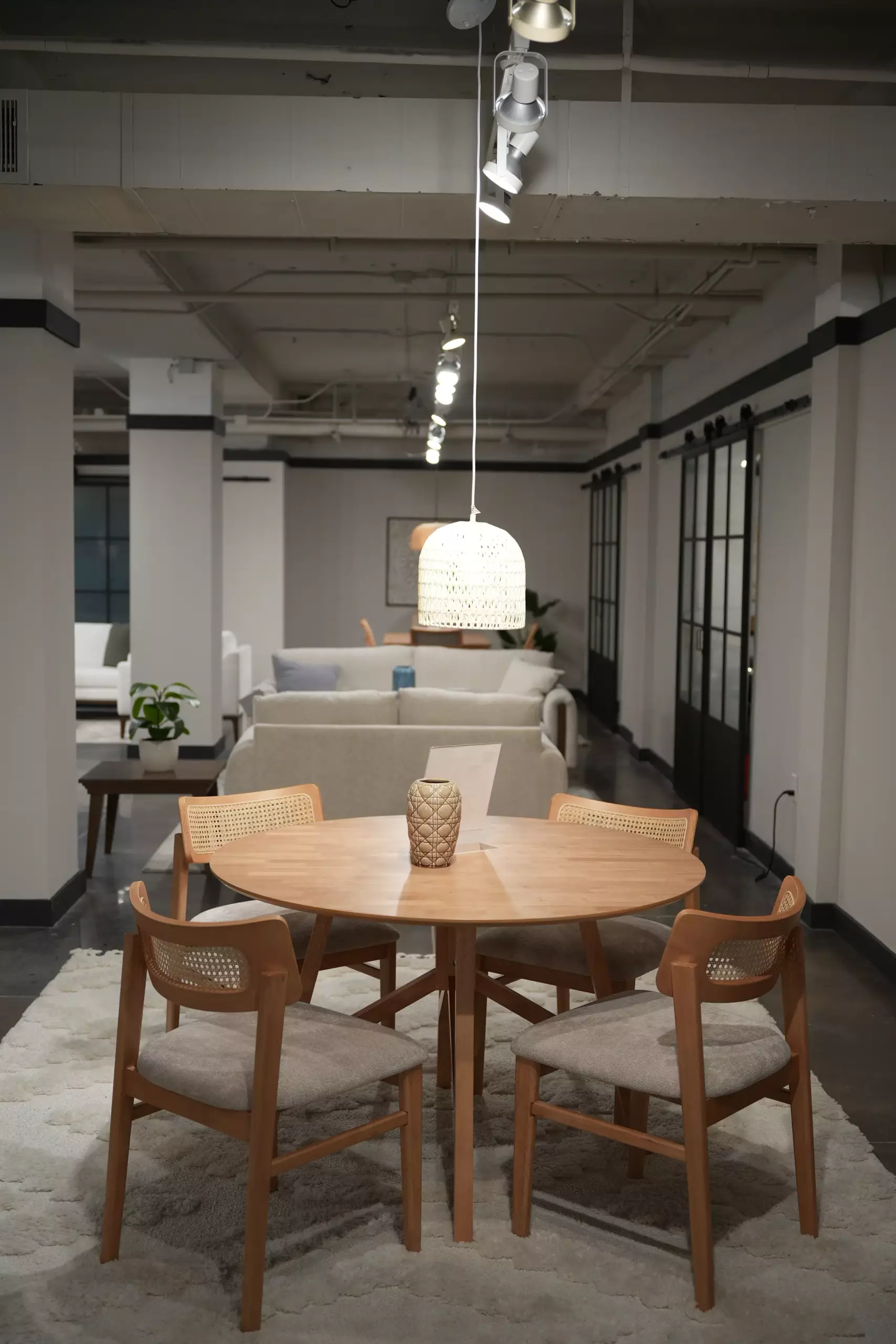 Round wood dining table with cane-back chairs for retailers and dealers