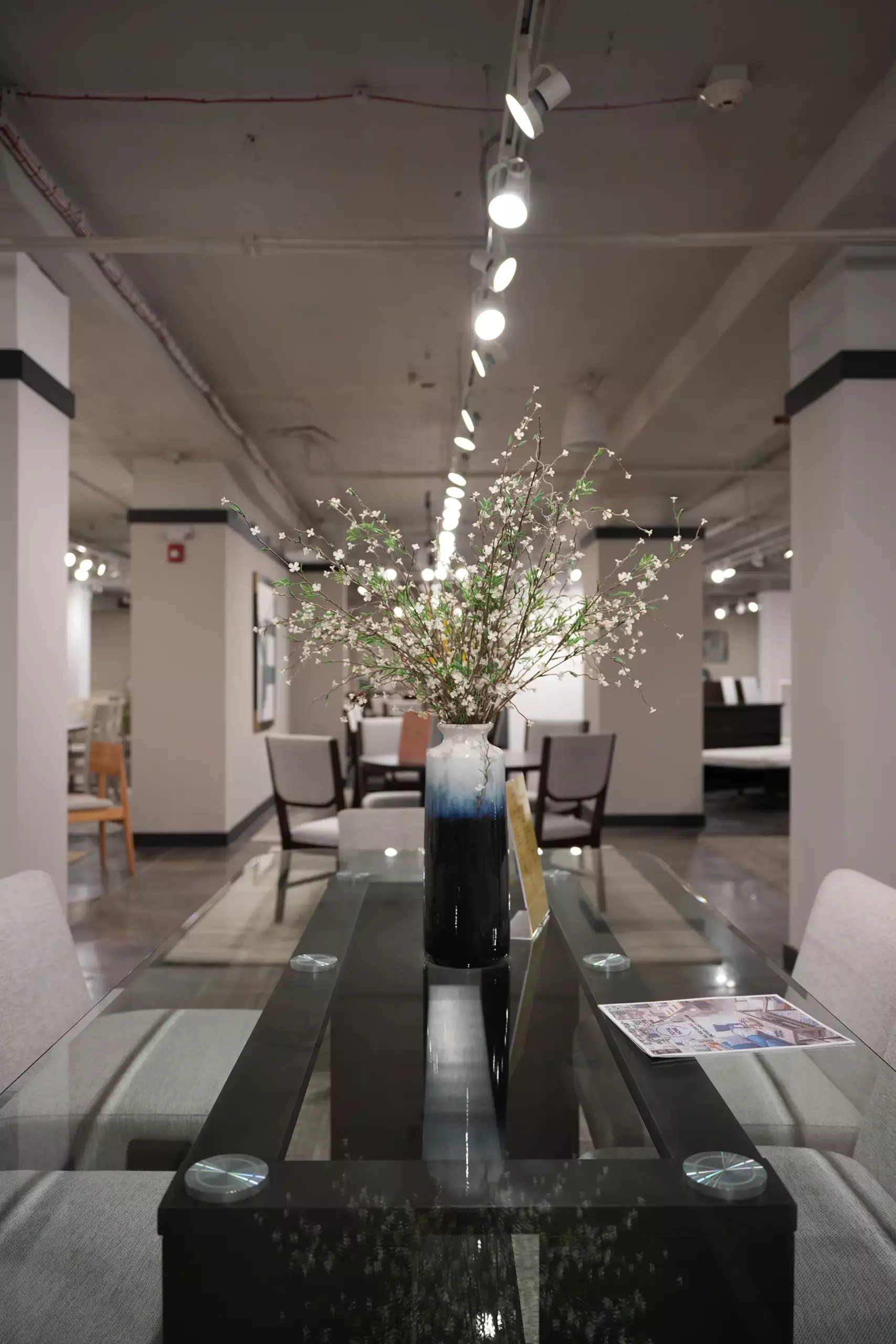 Glass-top dining table set for wholesale furniture buyers at Lifestyle showroom