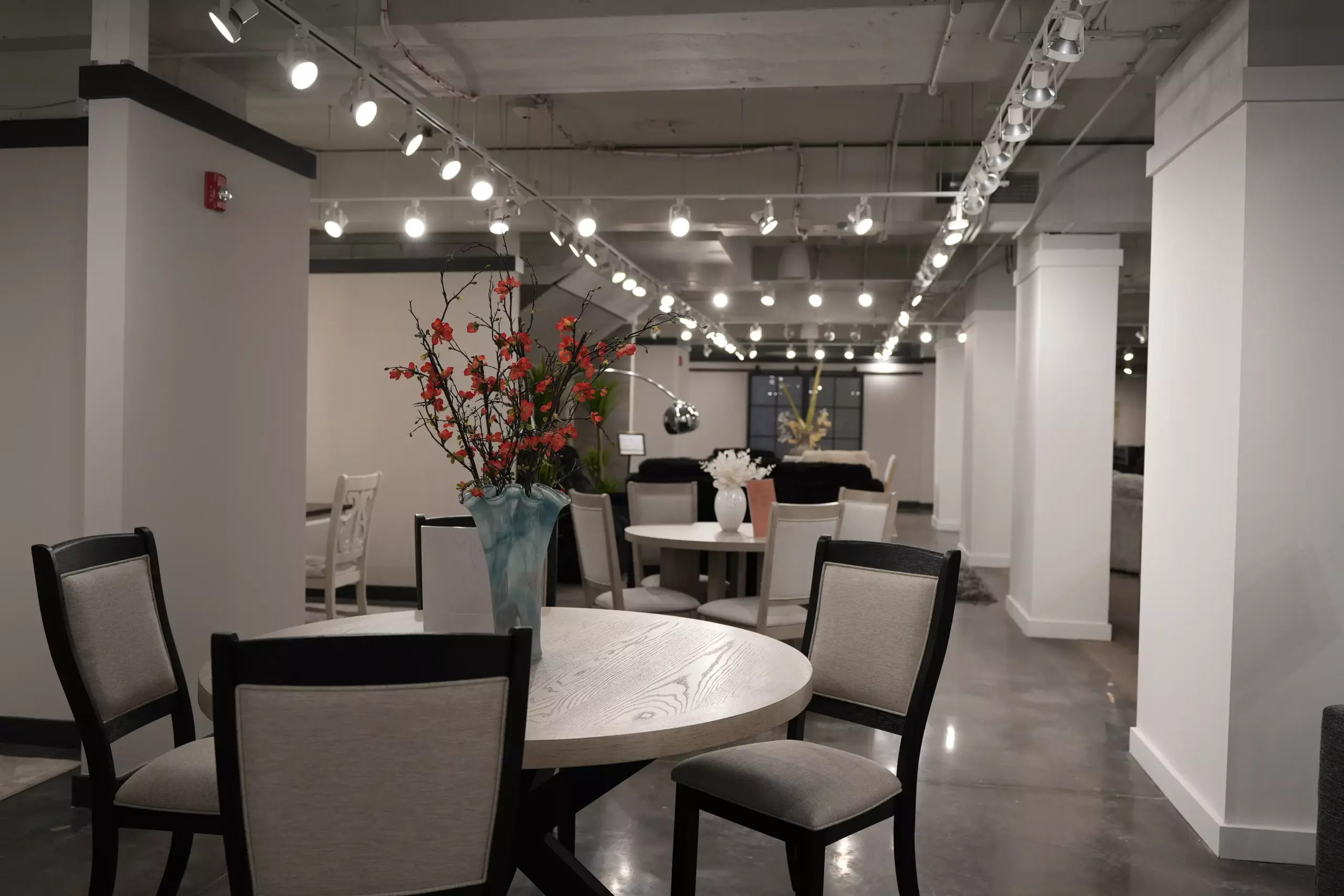 Round dining table set with upholstered chairs for furniture retailers