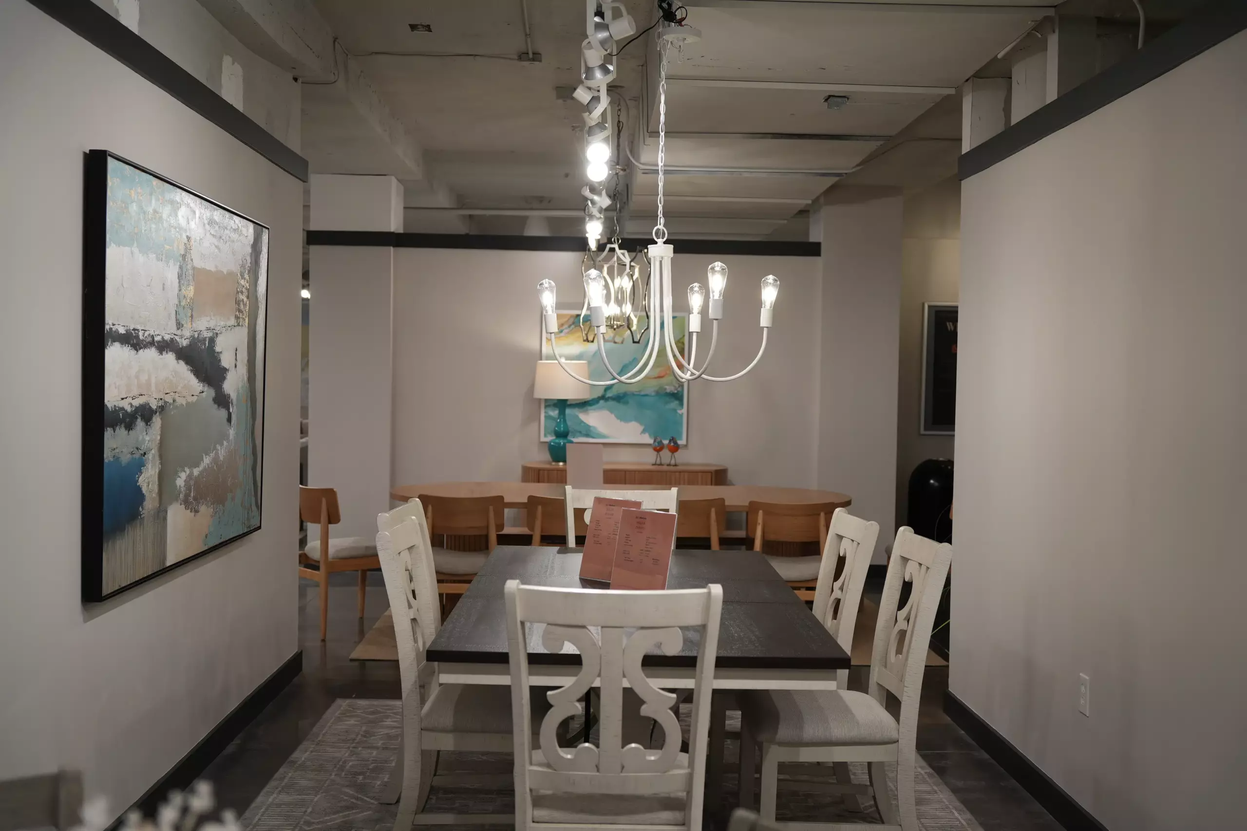 Rectangular dining set with white chairs and chandelier for furniture dealers